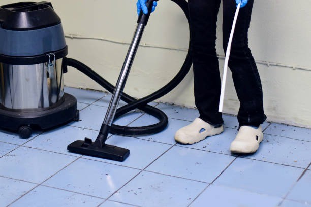 Professional using floor cleaning machine for deep tile wash